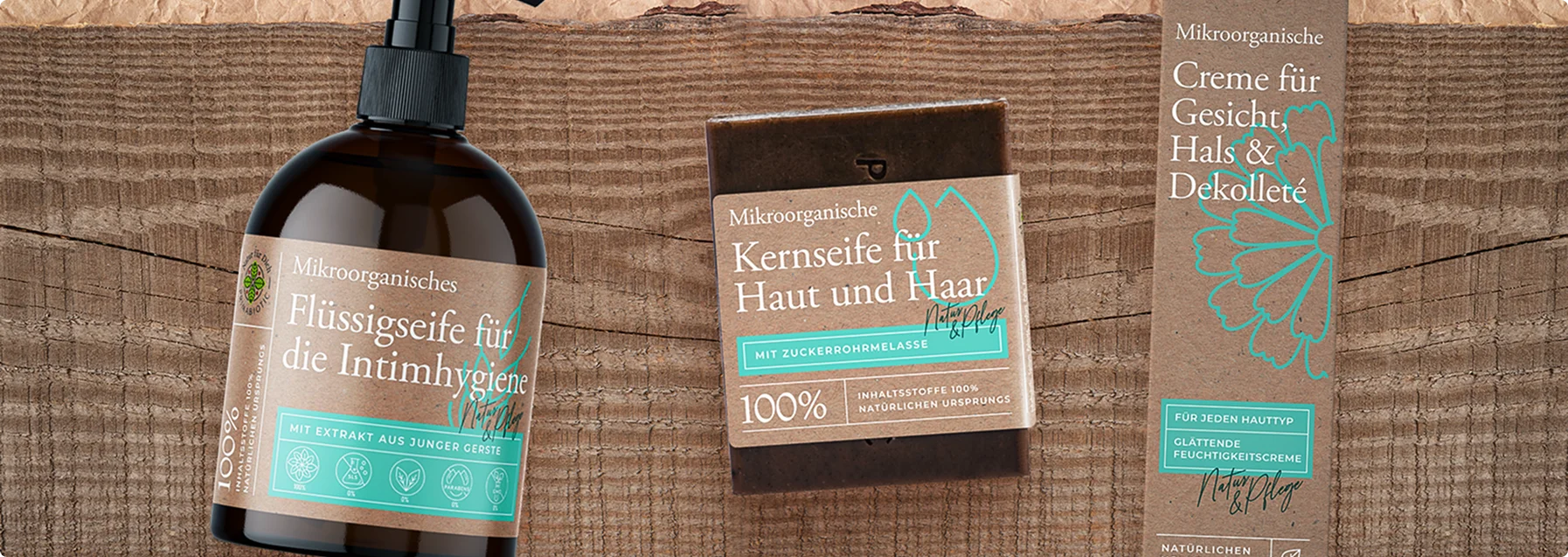 Na obrazku widoczne są trzy produkty do pielęgnacji ciała. Etykiety są w języku niemieckim, opisując produkty jako organiczne mydła oraz krem do twarzy, szyi i dekoltu.